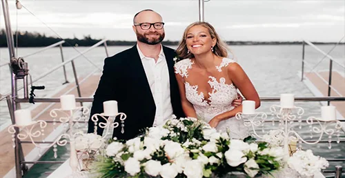 Wedding couple with flowers and table decorations on a boat