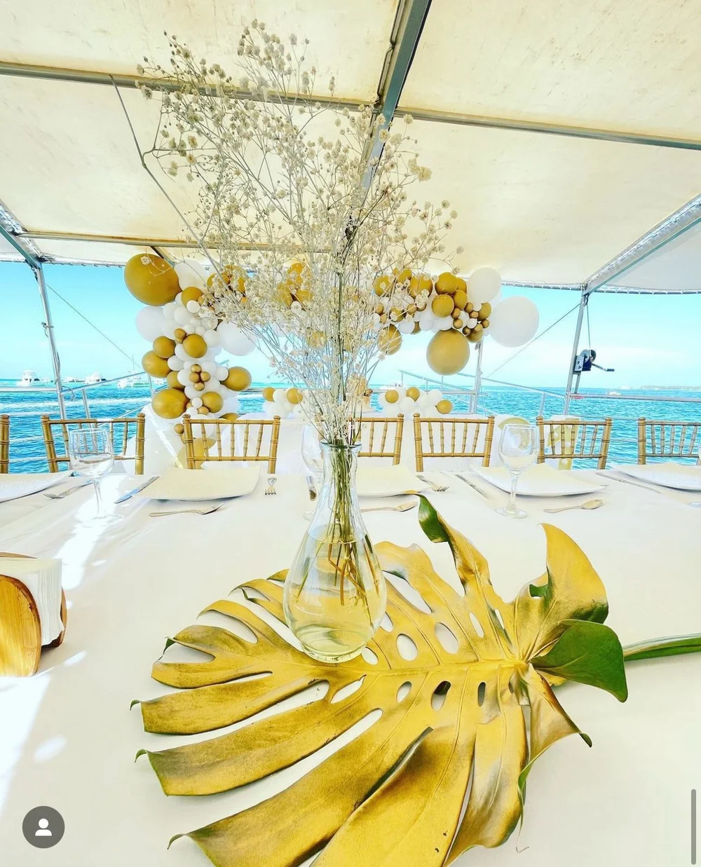Gold and white birthday decorations on a catamaran