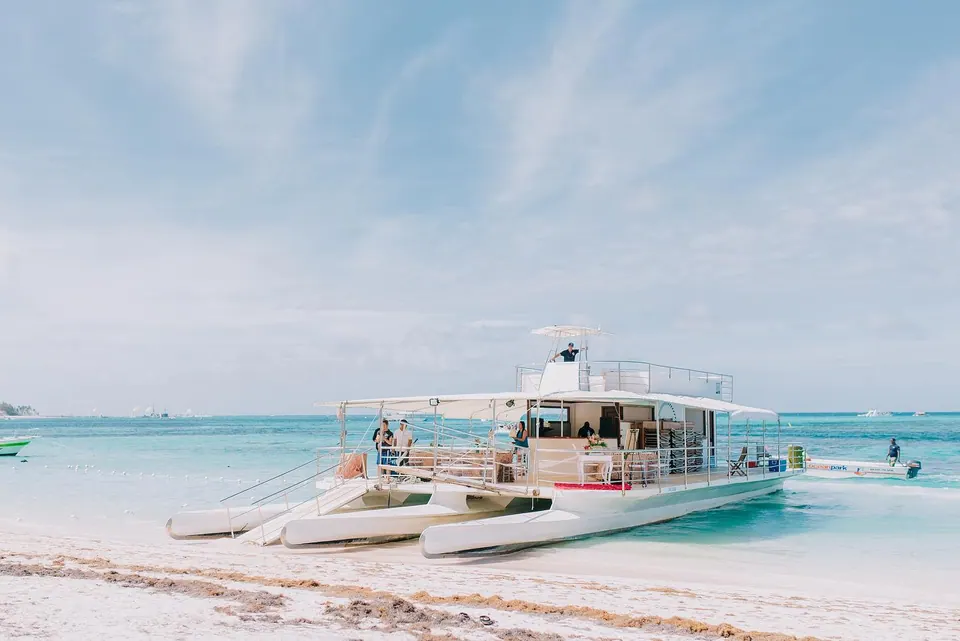 Large group catamaran anchored in crystal clear water in Punta Cana