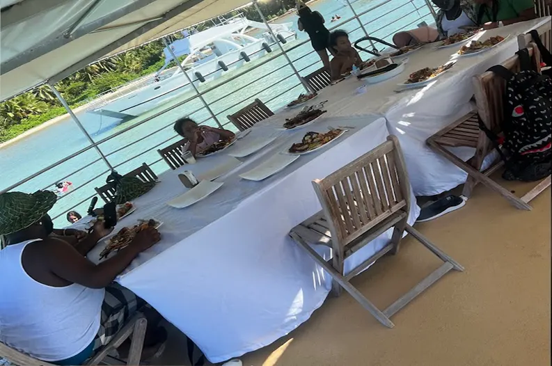 Happy travelers eating lunch on a Punta Cana catamaran trip